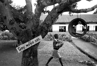 Interplast, 103-019-09
Ragazzino cammina dietro a un albero su cui è appeso avviso "say no to sex", 2008
Nkokonjeru (Uganda)